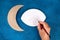 Diy Ramadan kareem crescent moon with a star from a disposable cardboard plate and gold paint