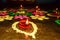 Diya Oil lamp in Rangoli decoration in Diwali festival. Concept of removing darkness