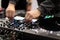DJ mixes tracks on a professional MIDI controller