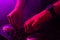 Dj mixing on turntables with color light effects. Soft focus on hand. Close-up.