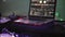 Dj spinning at turntable on party in nightclub. Laptop. Purple spotlights.