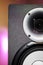 DJ studio monitor speaker with disco lighting background