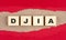 DJIA word on wooden cubes on red torn paper , financial concept background