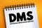 DMS - Database Migration Service acronym text on notepad, technology concept background