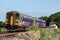 Dmu train in Northern livery at Arnside signal box