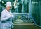 Dnepropetrovsk, Ukraine - 03.10.2016: Sweets factory. Sweets production process. A woman technologist monitors the work of an