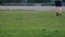 DNIPRO, UKRAINE - April 21, 2019: Unrecognizable boy kicks the ball in the stadium. Teenager trains in football. Focus on the legs