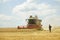 Dnipro, Ukraine - July 20, 2017: combine harvester in and agronomist in field near town Dnipro, Ukraine July 22,