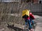 Dnipro, Ukraine - March 27, 2020: GLOVO delivery woman courier on bike with branded yellow thermal backpacks deliver customer