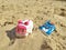 DnTwo toy cars in the sand in the sunlight