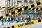 Do not cross.Barrier tape-quarantine,isolation. In the blur of the intersection where a group of people cross the street on the