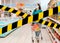 Do not cross.Barrier tape-quarantine,isolation.A woman in casual clothes with a medical mask on her face,rolls a grocery cart and