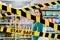 Do not cross.Barrier tape-quarantine,isolation.A young pretty Caucasian woman posing against the background of refrigerators with