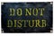 DO NOT DISTURB old shabby black metal plate with yellow letters