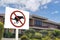 A do not dog poop sign in front of house. A large advisory or notice to owners to clean up after their dog