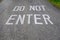 Do Not Enter stenciled on a sloping driveway in big white block letters