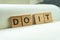 Do it print wording on wood block. on white notebook and office equipment.