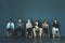 Do what you must to be prepared. Shot of a group of well-dressed business people seated in line while waiting to be