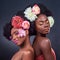 Do whatever makes you feel beautiful. two beautiful women posing together with flowers in their hair.