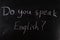 do you speak English question written with chalk on a blackboard