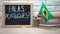 Do you speak Portuguese text on board, hand putting Brazil flag in box, language