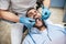 Do you want a better-looking smile? Dentist in latex gloves examining male patient, lying in dental chair with opened