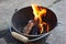 a Do it yourself backyard BBQ grill in a bucket with sausages and potatoes