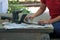 Do it yourself woman pours oil onto teeth of hedgetrimmer