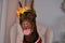 Doberman brown wearing wreath of flowers on head