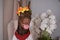 Doberman brown wearing wreath of flowers on head