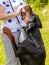 Doberman dog stands on its hind legs, hugging his mistress, the dog shows love for his mistress