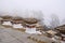 Dochu La Pass with 3-layered chortens stupas, on central hillock, along east-west road from Thimpu to Punakha, Bhutan