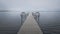 Dock with benches on foggy lake in Bemidji Minnesota