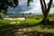 Dock with hammocks along the lake shore with dark blue cloudscape, El Remate, Peten, Guatemala