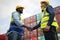 Dock manager and engineer worker shake hand with smile in shipping container yard. Import and export product. Manufacturing