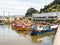 Dock at the mouth of the Valdivia River, with fishing boats moored in the harbor. Valdivia, River Region, southern Chile