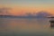 A dock overlooks a calm lake as the morning fog lifts in early autumn at Silver Lake, Castile, NY