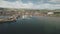 Dock at pier town cityscape aerial. Seagull over ocean bay. Yachts, boats, ships, vessels at wharf