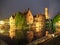 The dock of the Rosary, Rozenhoedkaai, with Belfry Tower by night, Bruges, Belgium