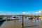 Dock with ships under a bright blue sky