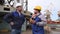 Dock worker and engineer have serious talk, then laugh and give high five in cargo port