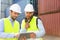 Dock worker and supervisor checking containers data on tablet