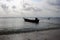 Docked boat on the seaside under sunset clouds