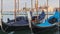 Docked Empty Gondolas on Wooden Mooring Piles, Venice, Italy.