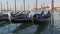 Docked Empty Gondolas on Wooden Mooring Piles, Venice, Italy.