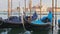 Docked Empty Gondolas on Wooden Mooring Piles, Venice, Italy.