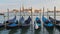 Docked Empty Gondolas on Wooden Mooring Piles, Venice, Italy.