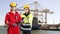 Dockers posing in front of a container ship