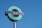 Docklands Light Railway sign against blue sky