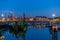 The docks of Blankenberge full with boats at night, city architecture of a popular town in Belgium